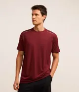 Remera deportiva masculina de manga corta con cuello redondo, confeccionada en tejido técnico con tecnología Dry para mayor transpirabilidad. Presenta detalles reflectantes en los hombros y un diseño liso en color verde melange.