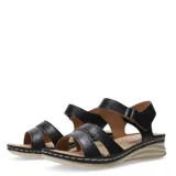 Sandalias de mujer con tiras de cuero sintético negro, una de ellas con textura grabada, cierre con velcro en el tobillo y suela de plataforma baja en color beige con costuras decorativas.