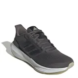Championes de running Adidas modelo Ultrabounce, color gris oscuro con entresuela blanca y suela gris claro. Presentan diseño de malla transpirable, cordones al tono y las icónicas tres tiras laterales en material sintético.