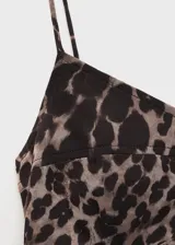 Vestido midi de tirantes finos con estampado animal print de leopardo. Presenta un diseño entallado con fruncidos laterales y cuello escotado.