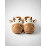 Pantuflas de peluche con diseño de vaca, confeccionadas en piel sintética suave. Cuentan con suela de goma antideslizante y diseño abierto en el talón.