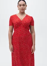 Vestido midi de corte recto con estampado floral, cuello en pico y mangas cortas. Presenta una abertura lateral en la falda y cierre de cremallera lateral.