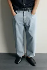Jeans tapered wide fit de hombre, confeccionados en denim de algodón con efecto lavado en tono azul oscuro. Presentan diseño de cinco bolsillos, tiro medio, corte relajado y cierre frontal con cremallera y botón.