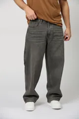 Jean baggy de corte amplio, estilo carpintero, color gris oscuro con efecto acid wash y costuras en contraste.