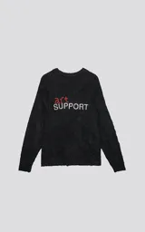 Sweater de punto negro con textura suave, cuello redondo y diseño oversize. Presenta un bordado frontal con la frase 'art SUPPORT' en letras rojas y blancas, y un pequeño detalle de tijeras bordado en la nuca.