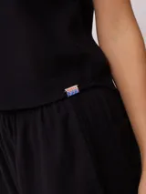 Musculosa color verde oliva, de corte recto y sin mangas, confeccionada en tejido de lino y algodón.