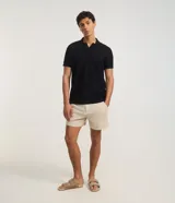 Bermuda color beige confeccionada en viscolino, de corte recto, con bolsillos laterales y traseros.