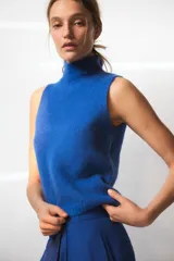 Chaleco de punto rojo con cuello subido y manga sisa.