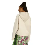 Canguro corto de mujer Adidas en colaboración con Farm Rio, color beige con estampado frontal de tucanes y hojas, y las icónicas tres tiras de la marca en color negro en las mangas.