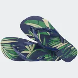 Ojotas Havaianas modelo Aloha con estampado de hojas de palmera en tonos beige, marrón y negro, sobre base blanca. Tiras blancas con textura.