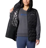 Campera híbrida Columbia con cuerpo acolchado negro y mangas de tejido gris. Presenta capucha integrada, cierre frontal y bolsillos laterales con cierre.