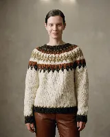 Buzo de tejido de punto con diseño de jacquard en el canesú y en los puños, de cuello redondo y manga larga.