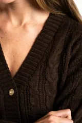 Cardigan de punto con diseño de trenzas, color marrón oscuro, con escote en V, cierre frontal de botones dorados y bolsillos delanteros.