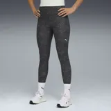 Calza deportiva Puma de tiro alto y largo 7/8, con diseño jaspeado en tonos gris oscuro y negro. Presenta el logo de la marca estampado en blanco en la pierna izquierda.