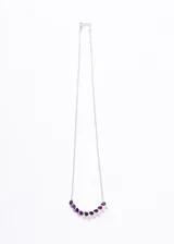 Collar de plata 925 con una hilera curva de piedras de amatista talladas en forma de gota. La cadena es de eslabones finos.