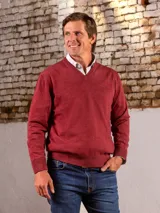 Sweater de hilo color ladrillo, con escote en V y logo bordado en el pecho.
