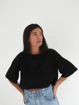 Top negro de tejido de punto con mangas cortas y bordado en el frente.