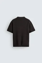 Camiseta de punto de algodón con textura perlada, corte regular fit, cuello redondo y manga corta con terminaciones en rib.