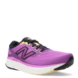 Championes New Balance Running eVOZ, color violeta con detalles en amarillo y negro.