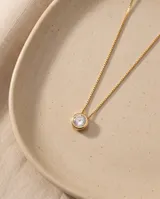 Collar de acero con baño dorado, de cadena fina estilo veneciano, con un dije colgante redondo tipo punto de luz engastado con circonía.