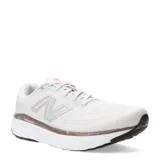 Championes de running New Balance modelo Evoz V4, color blanco con detalles en gris y toques de color salmón. Presentan entresuela Fresh Foam X para mayor amortiguación, parte superior de malla técnica transpirable con refuerzos sintéticos y suela de goma de alta durabilidad.