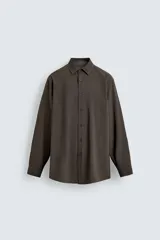 Camisa slim fit de color marrón oscuro, con cuello italiano, manga larga con puños abotonados y cierre frontal de botones. Confeccionada en tejido de fácil cuidado que minimiza la necesidad de planchado.
