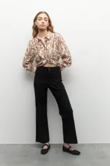 Pantalón ancho de tiro alto, color negro, con pretina y doble botón metalizado.