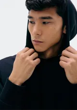 Buzo con capucha de corte clásico, confeccionado en tejido de algodón, con bolsillo frontal tipo canguro y puños acanalados.