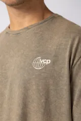 Remera de algodón con efecto lavado, color marrón, de corte holgado y manga corta. Presenta pequeños estampados gráficos en el pecho.