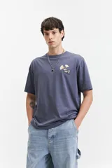 Remera de manga corta color azul grisáceo, con escote redondo y ajuste regular. Presenta un estampado frontal de flores blancas y amarillas con texto "ALL DAY EVERY DAY" y "mindset".