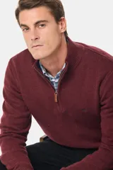 Buzo tejido de lana con cuello alto y medio cierre metálico frontal. Presenta puños y ruedo acanalados, con logo bordado en el pecho.