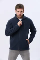 Campera polar de abrigo azul marino con cuello alto y cierre frontal completo. Cuenta con bolsillos laterales y un bolsillo vertical en el pecho con cierre.