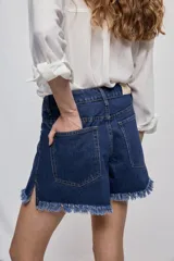 Short de jean blanco de tiro medio con silueta relajada y detalle de ruedo desflecado con flecos.