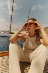 Pantalón tejido color crema, de algodón, con cintura elástica y cordón ajustable.