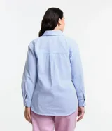 Camisa de corte clásico y largo, confeccionada en tejido anarruga con estampado de rayas verticales en tonos azul y blanco. Presenta cuello inglés, cierre frontal abotonado y mangas largas con puños.
