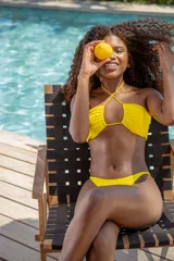 Top de bikini amarillo con tirantes finos que se cruzan en el frente y se atan al cuello.