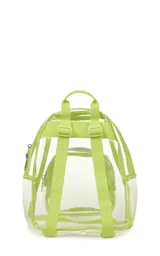 Mochila mini transparente de la marca JanSport con ribetes y correas en color lila pastel. Cuenta con un compartimento principal y un bolsillo frontal con cierre.