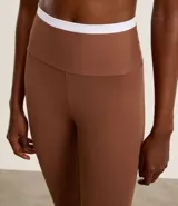 Pantalón legging deportivo color marrón con cintura alta en contraste color blanco. Confeccionado en tejido de poliamida y elastano, de ajuste ceñido al cuerpo.