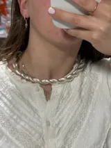 Gargantilla plateada gruesa con diseño trenzado.