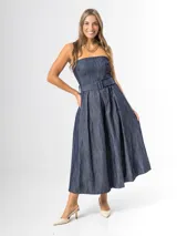 Vestido midi strapless de denim azul, con escote recto, espalda elastizada y falda amplia con pliegues. Incluye un cinto del mismo material con hebilla.
