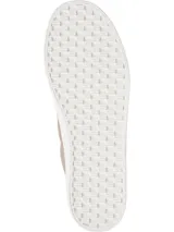 Zapatillas Tommy Hilfiger Essential de lona color beige con plataforma blanca, detalles metálicos dorados y talón en cuero sintético blanco con ribete dorado.