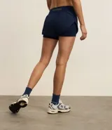 Bermuda deportiva tipo runner, color verde menta, confeccionada en microfibra con cintura elástica. Tiene un corte holgado y bajo redondeado.