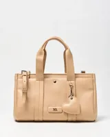 Cartera tipo tote de símil cuero color beige, con doble asa de mano, correa ajustable y desmontable, y llavero colgante en forma de corazón. Cuenta con detalle de logo metálico en el frente y broche a presión.