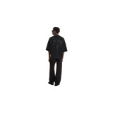 Remera negra de corte oversize de la marca Fear Of God, con cuello redondo y estampado frontal con el texto "Fear Of God Disciples" en tono oscuro.
