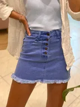 Minifalda de jean azul con botones frontales y ruedo desflecado.