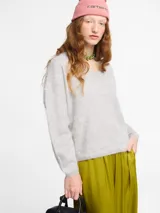 Sweater negro de silueta relajada con escote en V abierto, mangas largas y puños y ruedo cortos. Tejido extra suave tipo pelo.