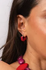 Aro de acero quirúrgico con diseño de argolla pequeña decorada con mostacillas rojas enroscadas.