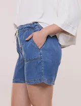 Short verde militar de tiro medio, confeccionado en lyocell con cintura elastizada y cordón tubular de ajuste con punteras metálicas. Cuenta con amplios bolsillos delanteros aplicados y diseño holgado.