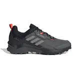 Championes de senderismo Adidas Terrex AX4 GORE-TEX, color gris con detalles en negro y naranja. Cuentan con membrana impermeable GORE-TEX y suela de caucho Continental.