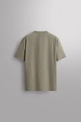 Camiseta de entrenamiento regular fit color beige, confeccionada en combinación de tejidos técnicos ligeros y elásticos con tecnología Quick Dry nivel 2. Presenta cuello redondo, manga corta, acabados con costuras planas y termofijadas, y detalle de logo estampado en el bajo.